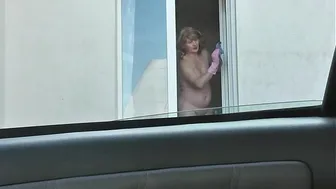 Nude woman neighbor sexy mature Milf without panties and bra washes windows her apartment. A taxi driver watches from car. Solo. Naked in public Peeping Outdoor Outside Publicly Big natural tits Pussy