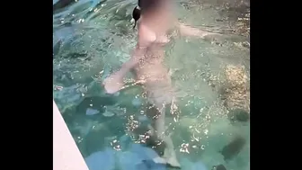 Beautiful girl taking off her swimsuit at the pool